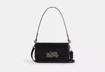 Measurements Length: 9.5" Height: 5.5" Width: 2.25" Materials Shiny refined calf leather Fabric lining Handle Detachable handle with 9.75" drop Strap Detachable strap with 20.75" drop for shoulder or crossbody wear Features Outside open pocket Inside zip and open pockets Stud closure